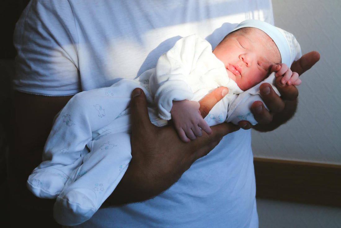 Nouveau-né endormi dans les bras de ses parents
